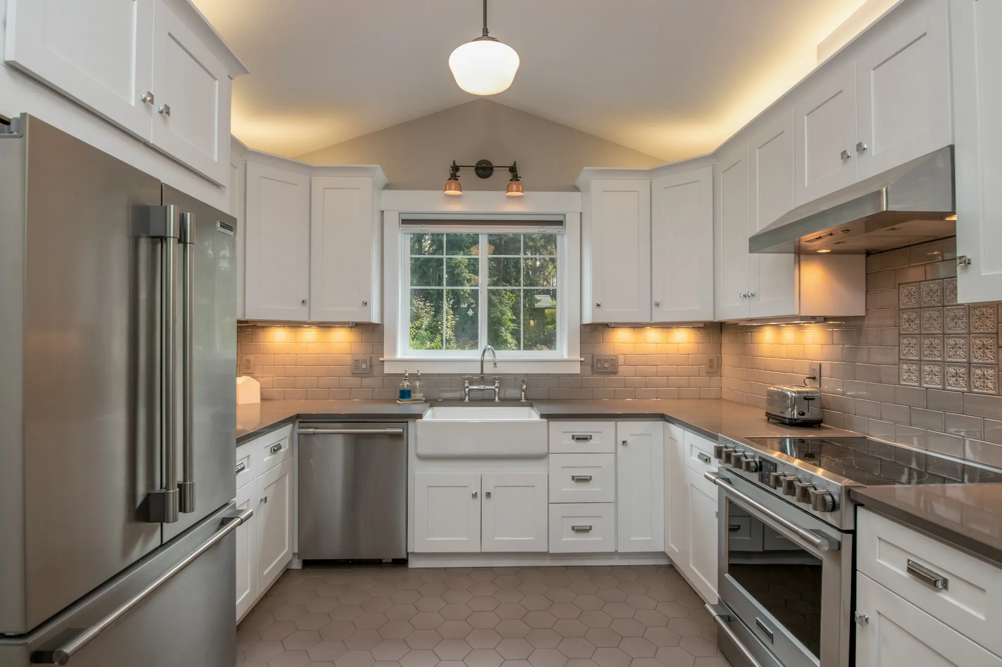 Finished kitchen with under-cabinet lighting and a bright window
