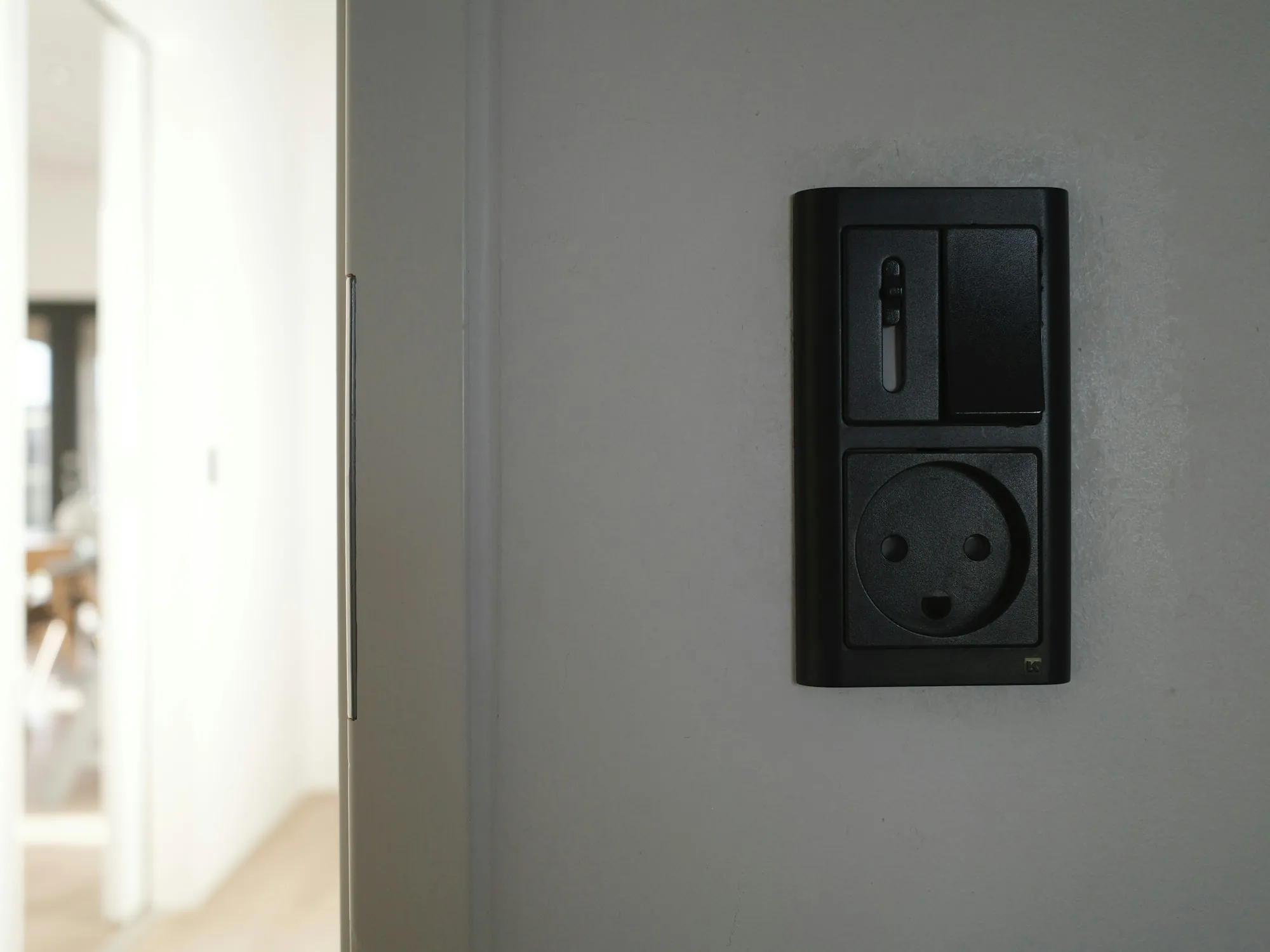 Modern light switch on a pale gray wall