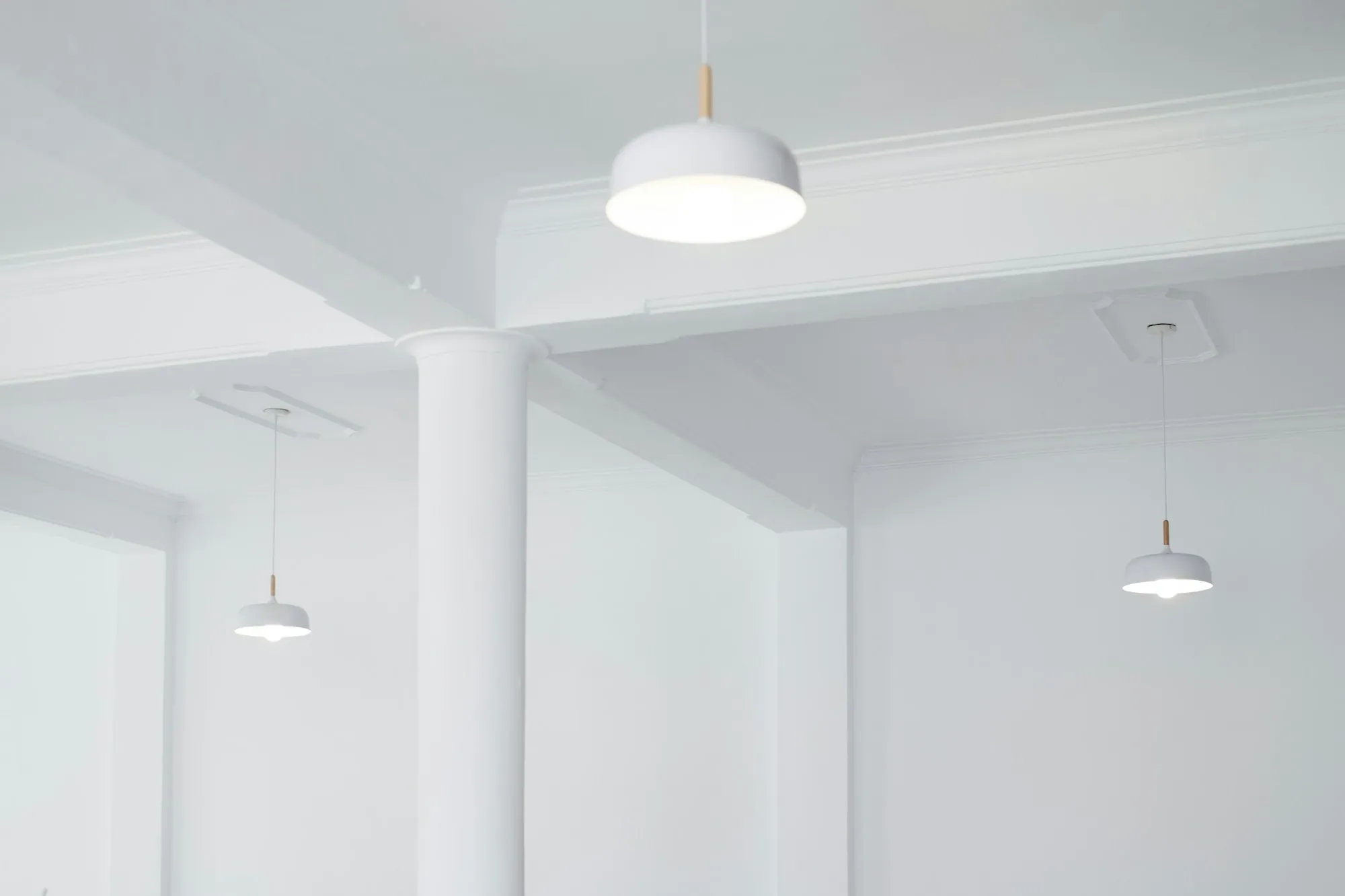 Bright white room with new pendant lights and recessed fittings